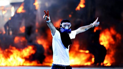 Civil unrest in Turkey...epa03740223 A protestor flashes V sign
