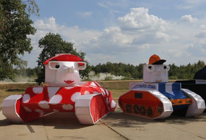A tank drives past decorations on course of Tank Biathlon world championship in Alabino